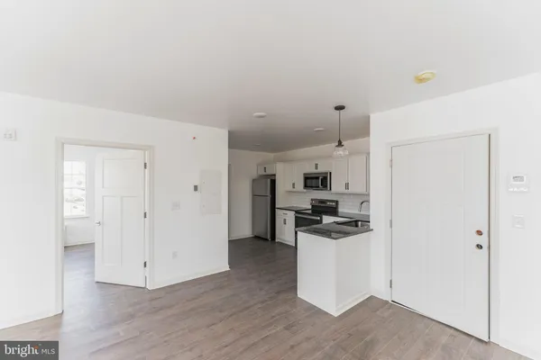 a kitchen with a refrigerator and a stove top oven