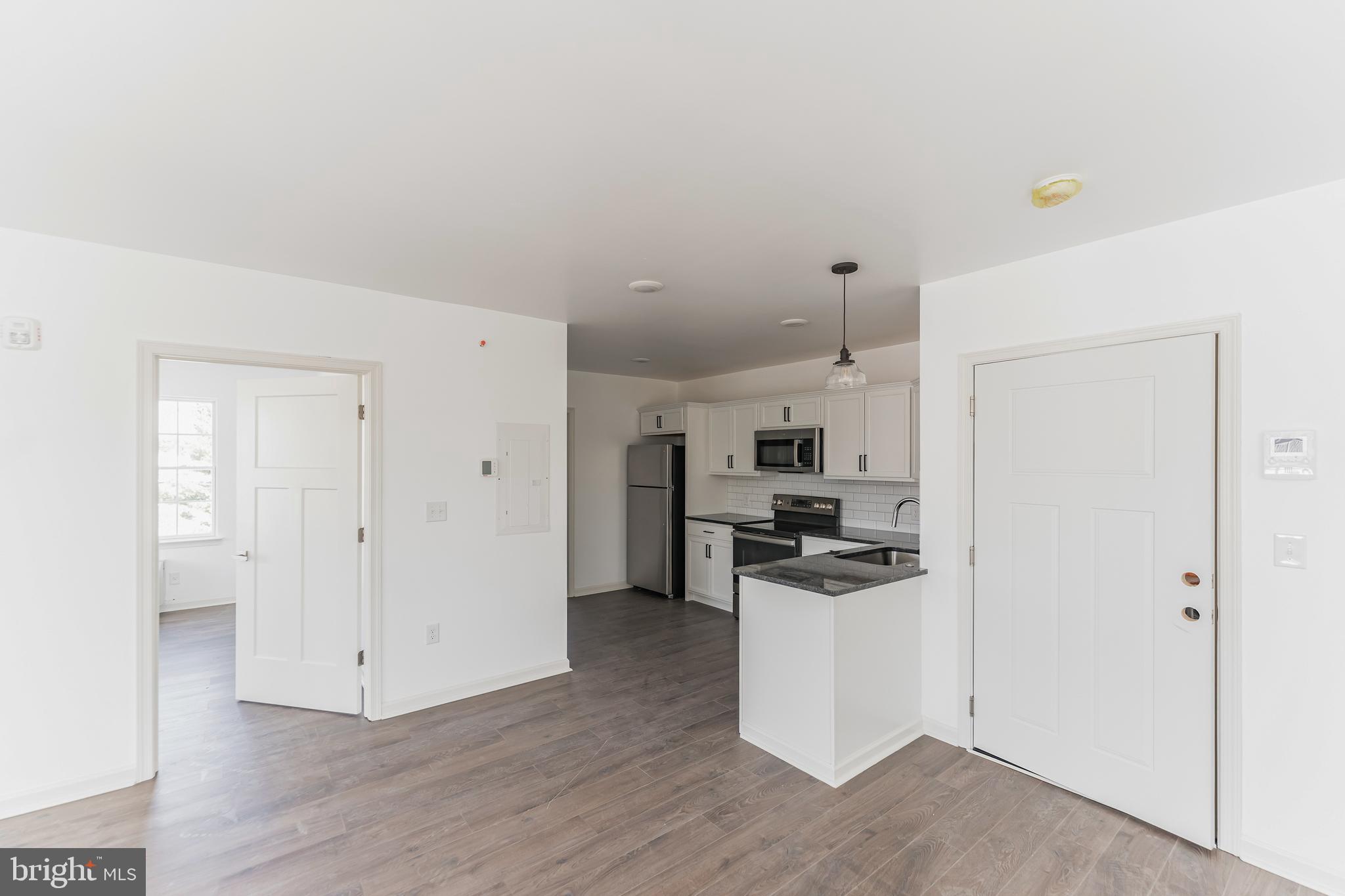 7105 Ridge Avenue, Unit A3 Philadelphia, PA 19128 - Photo 5 of 10 a kitchen with a refrigerator and a stove top oven