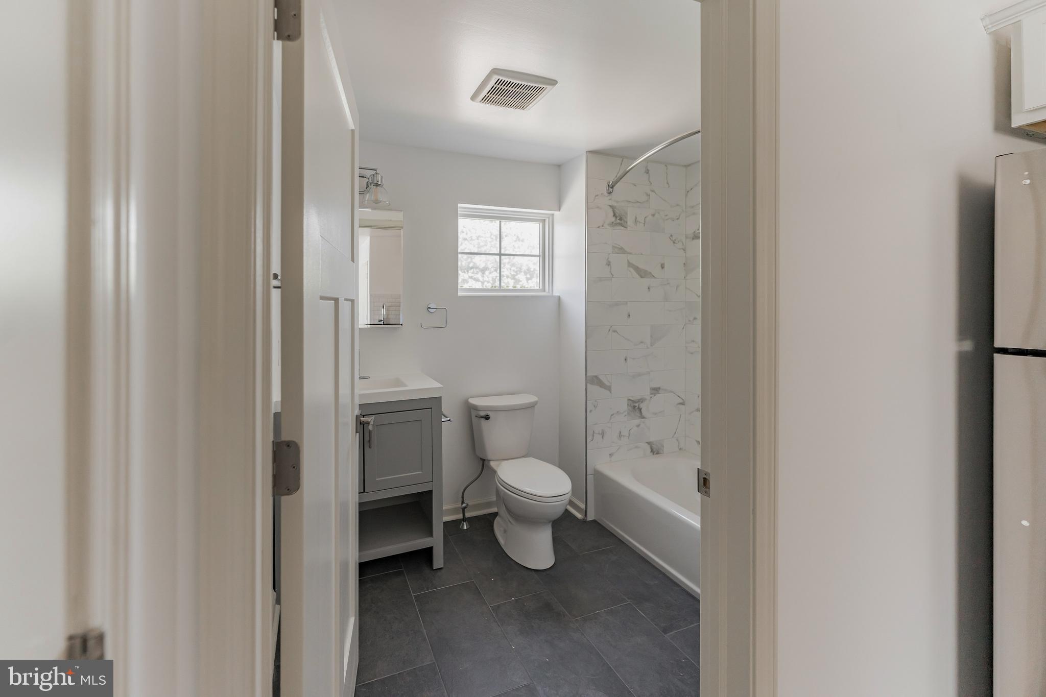 7105 Ridge Avenue, Unit A3 Philadelphia, PA 19128 - Photo 8 of 10 a bathroom with a toilet sink and shower