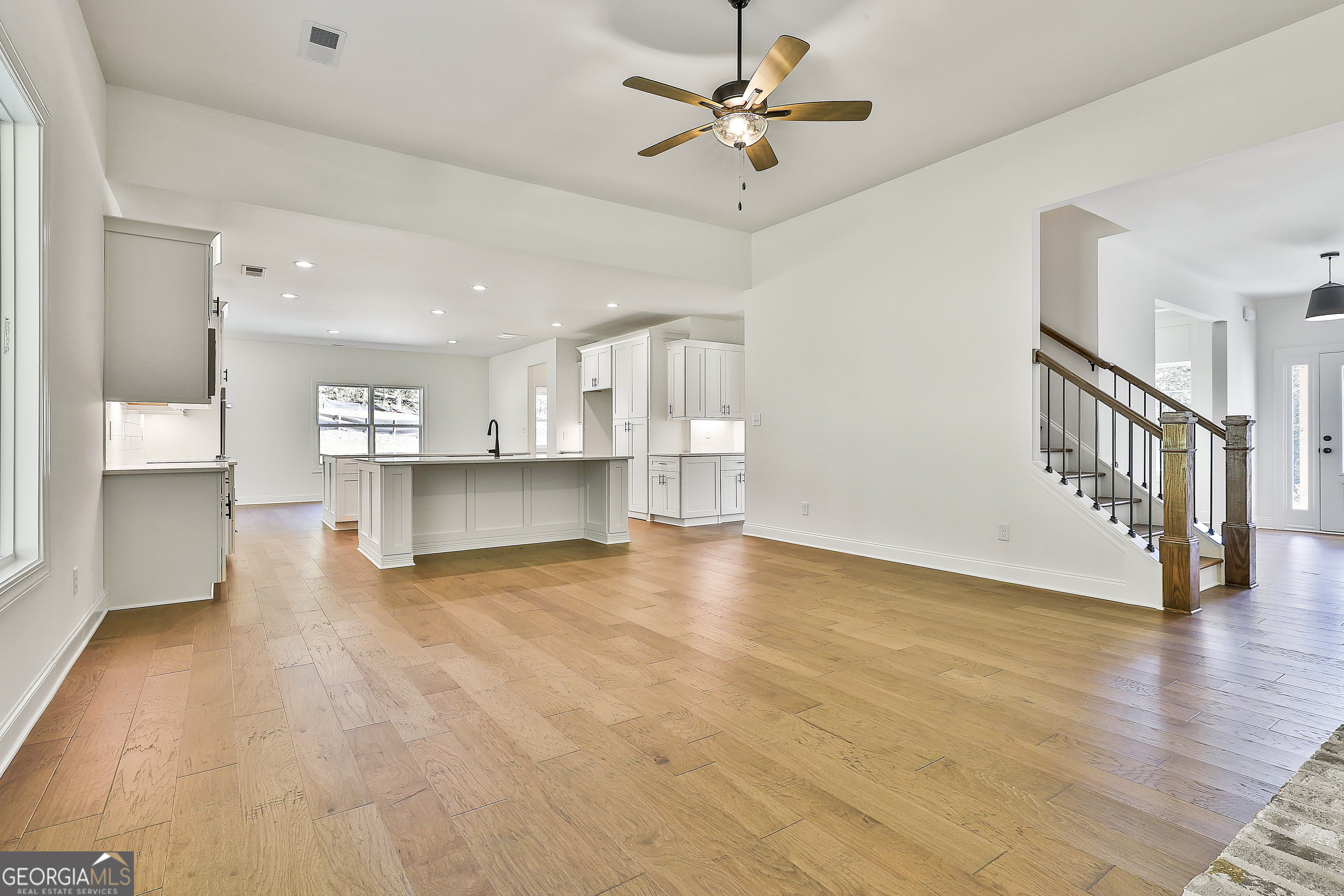 766 Wisteria Lane, Unit 55 Williamson, GA 30292 - Photo 16 of 52 a view of an empty room with a window and a kitchen