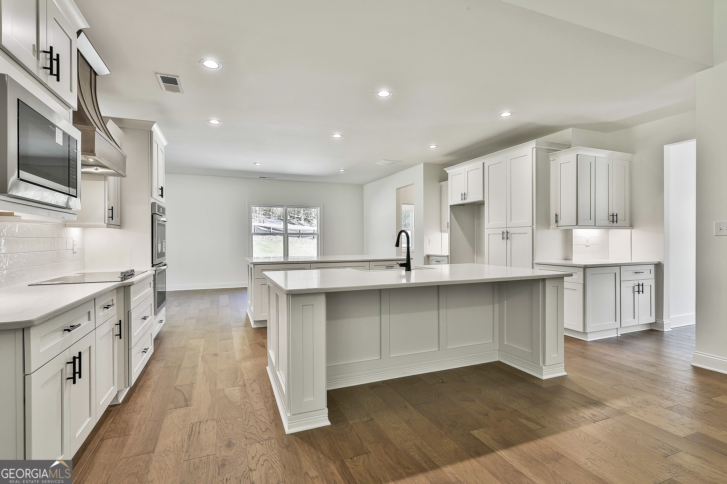 766 Wisteria Lane, Unit 55 Williamson, GA 30292 - Photo 17 of 52 a large kitchen with stainless steel appliances granite countertop a large counter top a sink and a stove