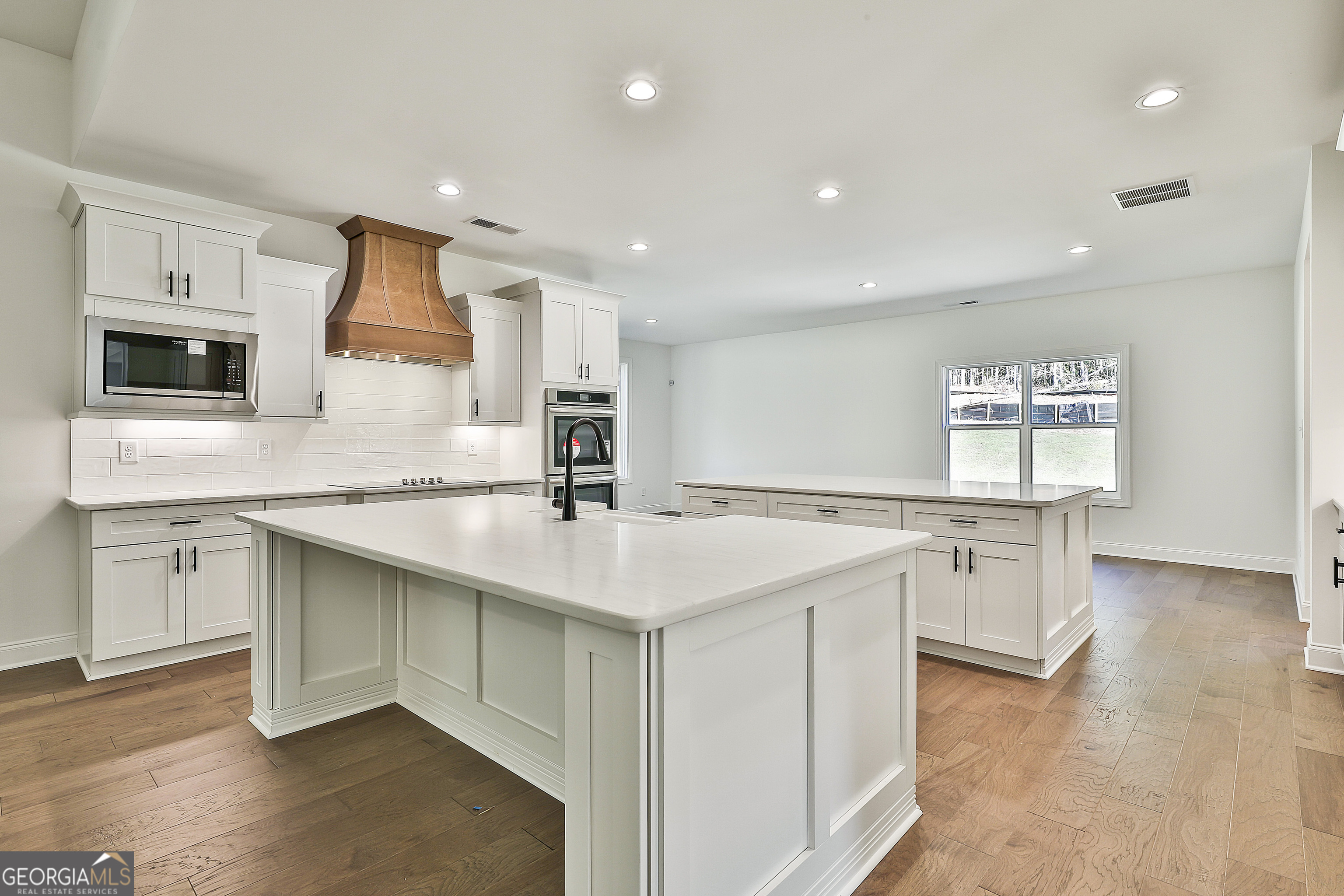 766 Wisteria Lane, Unit 55 Williamson, GA 30292 - Photo 19 of 52 a kitchen with a sink stove and microwave