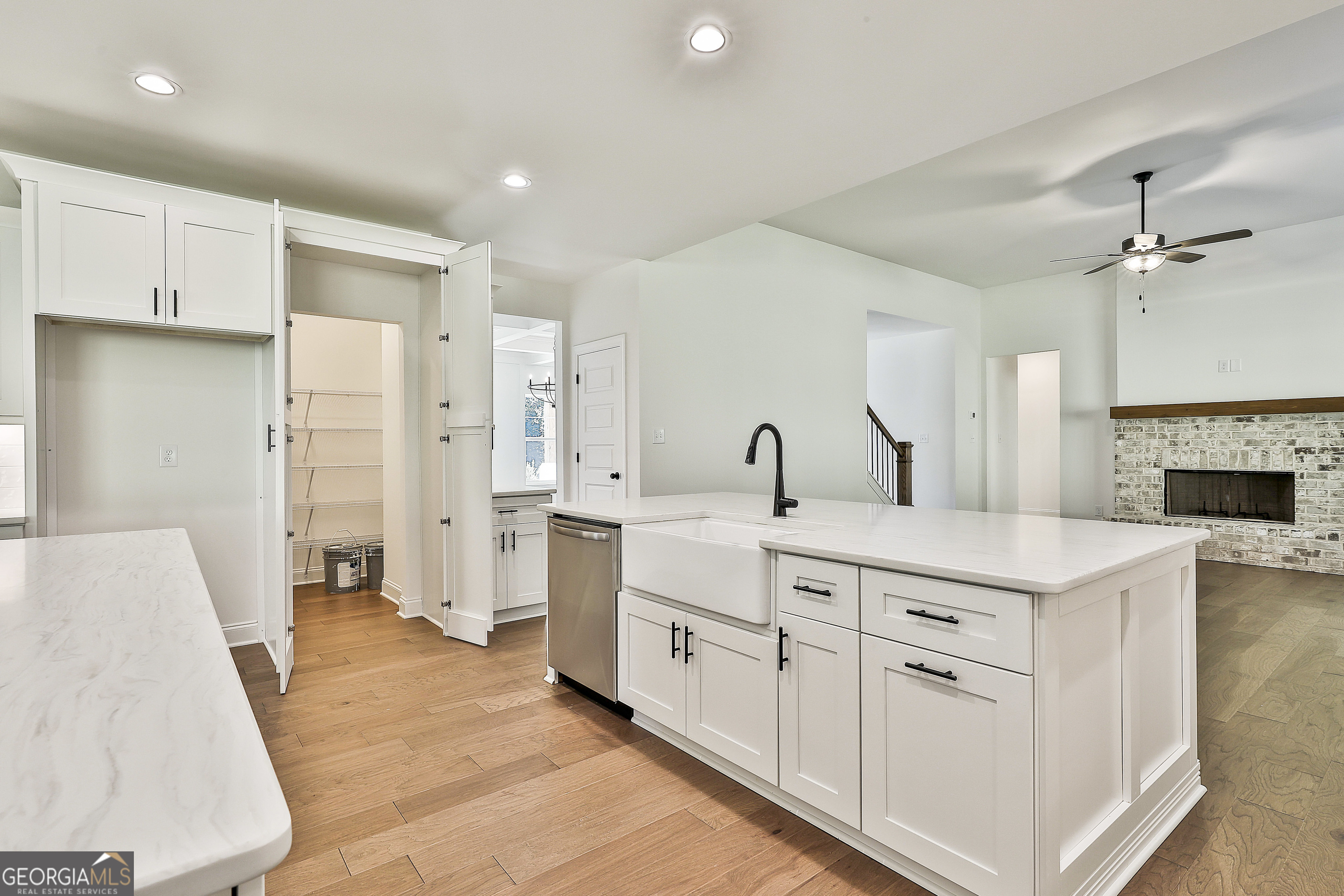 766 Wisteria Lane, Unit 55 Williamson, GA 30292 - Photo 22 of 52 a large white kitchen with a stove a sink a refrigerator and a fireplace