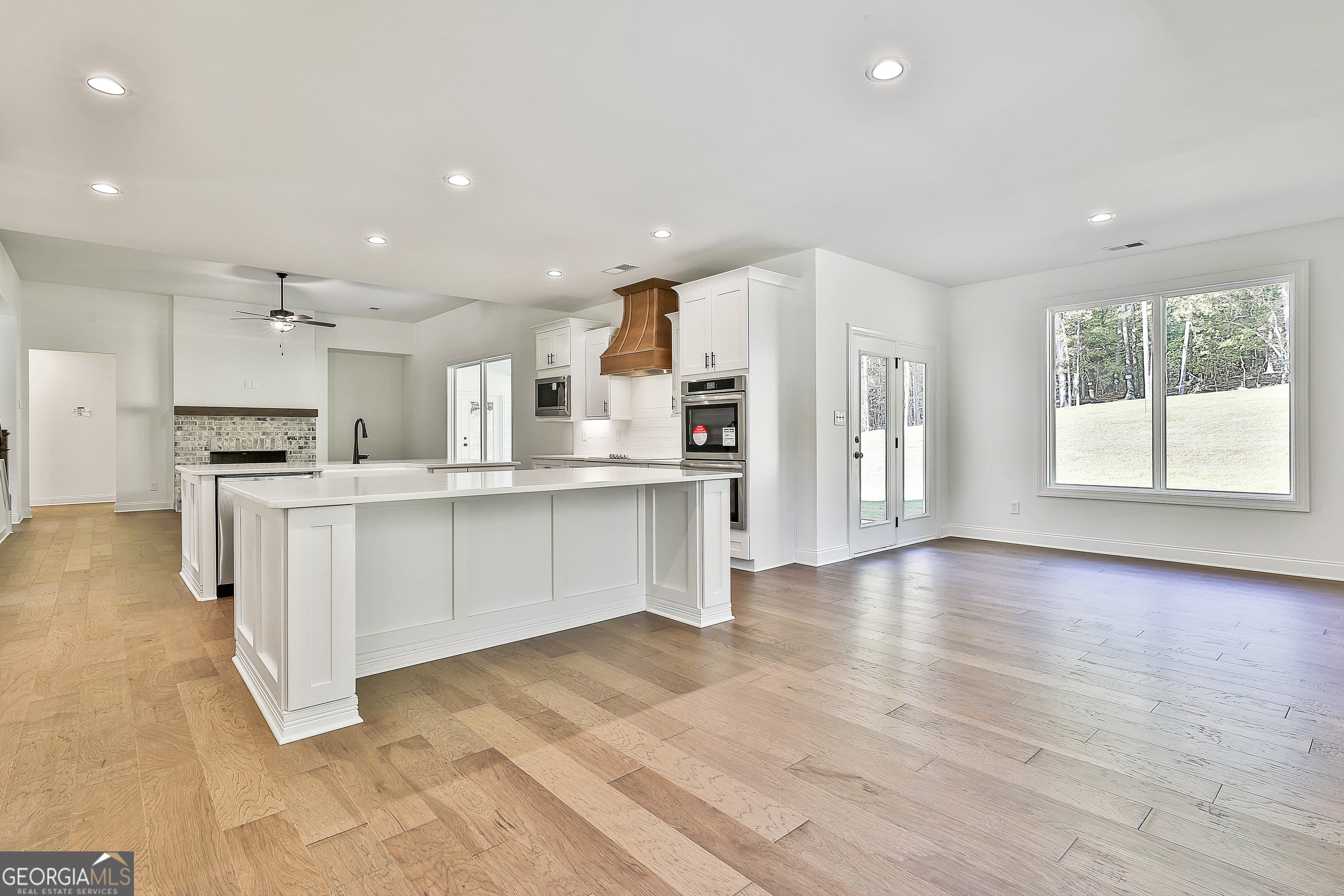 766 Wisteria Lane, Unit 55 Williamson, GA 30292 - Photo 25 of 52 a large kitchen with stainless steel appliances kitchen island granite countertop a large cabinets a sink and a stove top oven