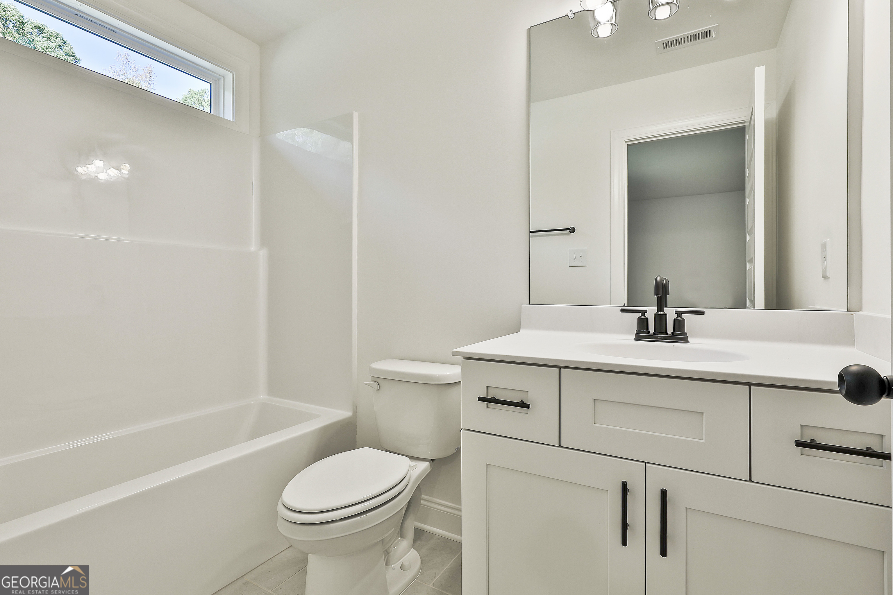 766 Wisteria Lane, Unit 55 Williamson, GA 30292 - Photo 42 of 52 a bathroom with a sink toilet vanity and tub