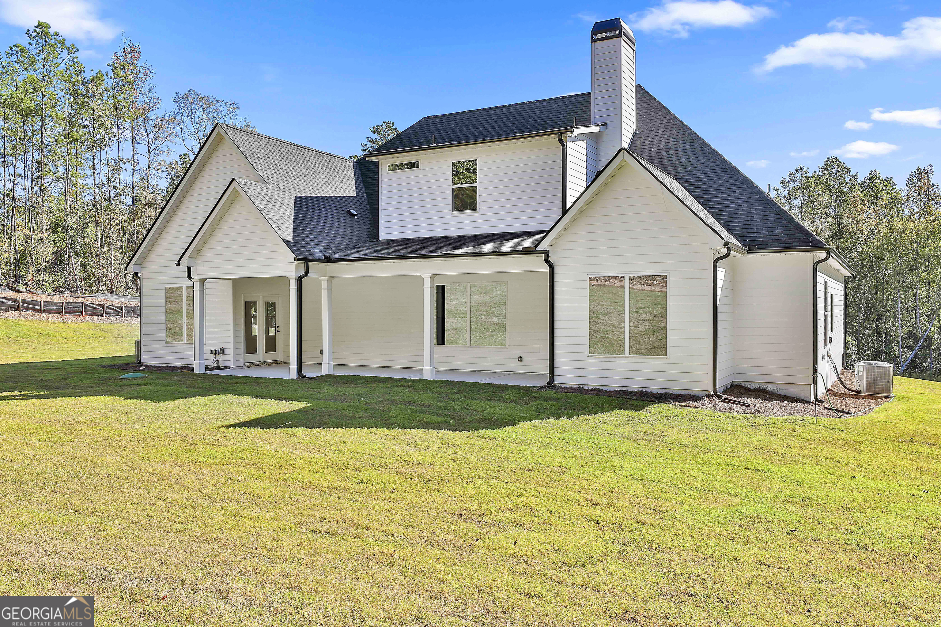 766 Wisteria Lane, Unit 55 Williamson, GA 30292 - Photo 49 of 52 a view of a house with a yard and a garage