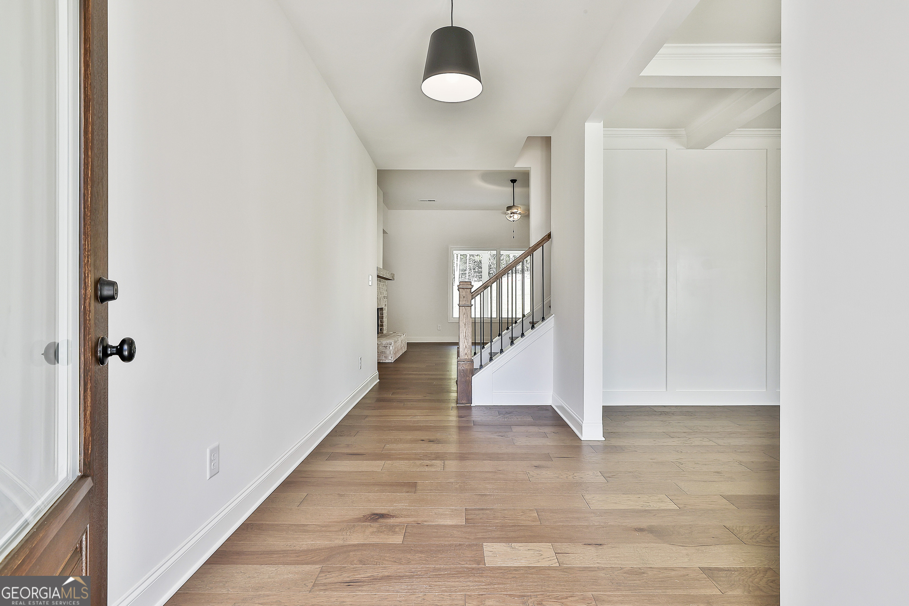 766 Wisteria Lane, Unit 55 Williamson, GA 30292 - Photo 7 of 52 a view of a hallway with wooden floor and staircase