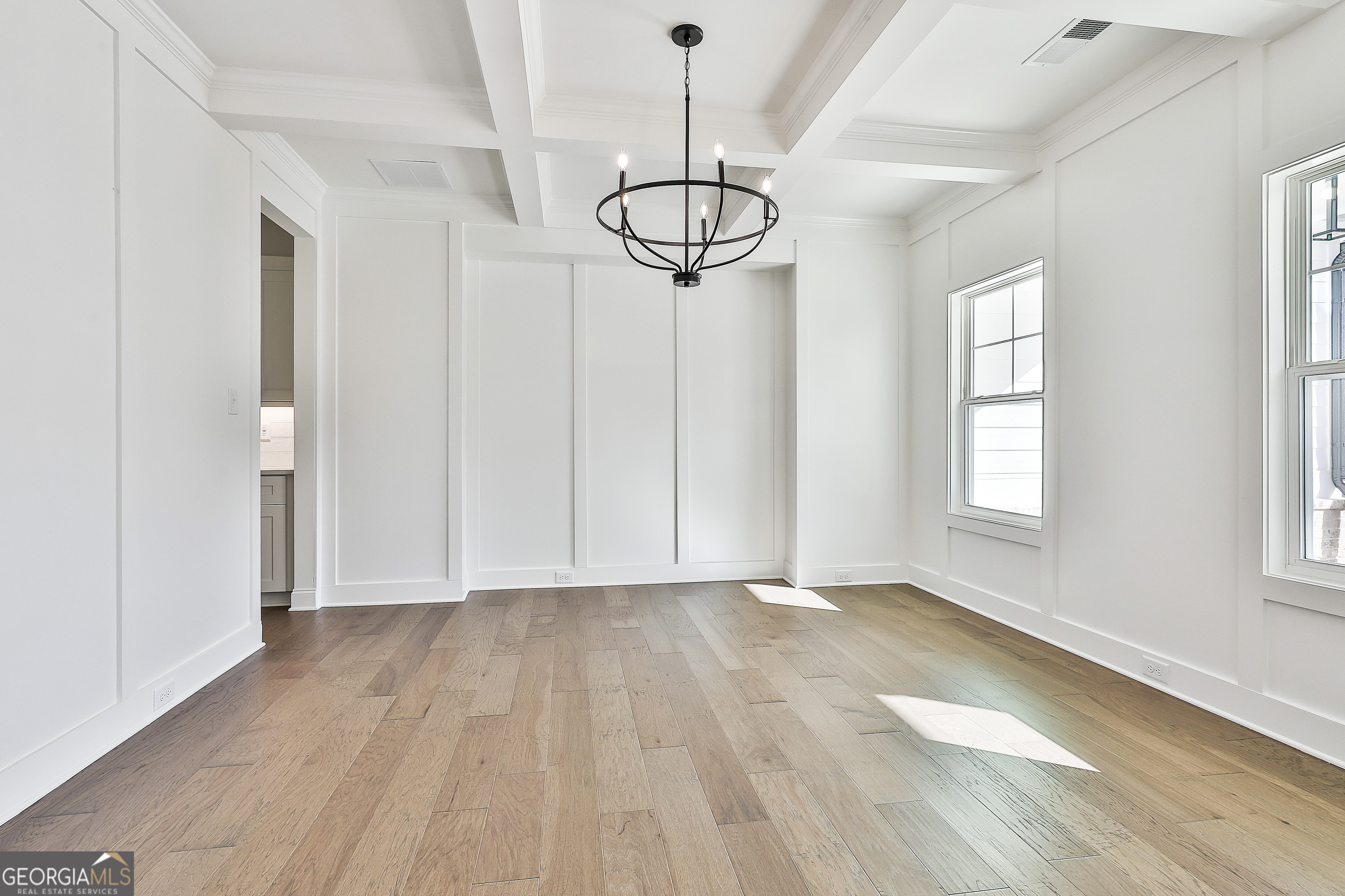 766 Wisteria Lane, Unit 55 Williamson, GA 30292 - Photo 9 of 52 a view of a room with wooden floor exposed radiator and windows
