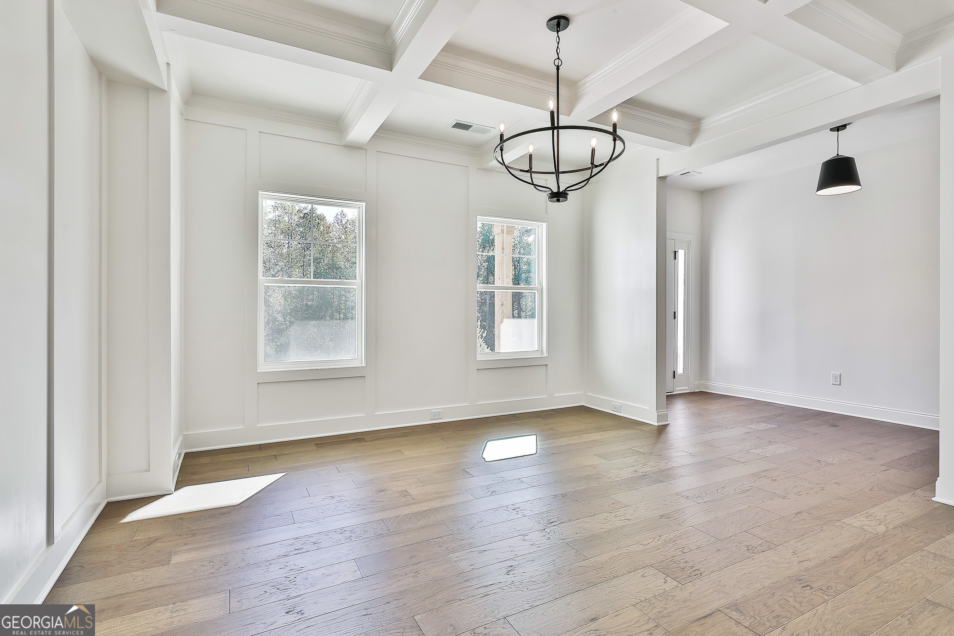 766 Wisteria Lane, Unit 55 Williamson, GA 30292 - Photo 10 of 52 a view of an empty room with wooden floor and window