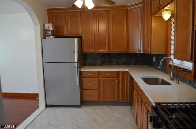 a kitchen with a refrigerator sink and cabinets