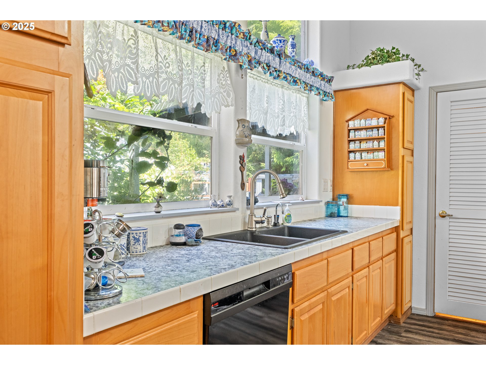 57418 Woodland Road Coquille, OR 97423 - Photo 12 of 39 a kitchen with stainless steel appliances granite countertop a sink and a window
