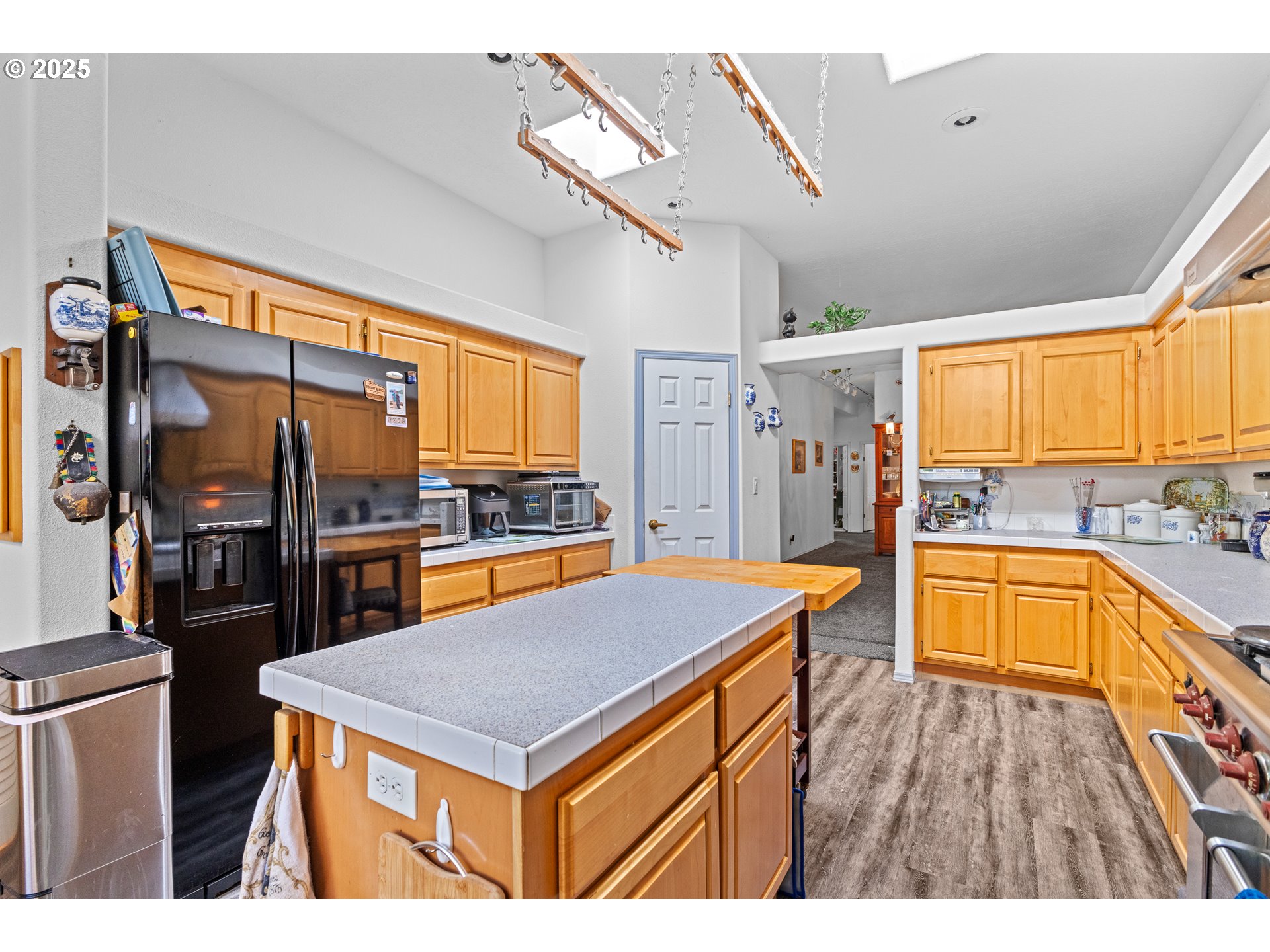 57418 Woodland Road Coquille, OR 97423 - Photo 13 of 39 a kitchen with stainless steel appliances granite countertop a sink and a refrigerator