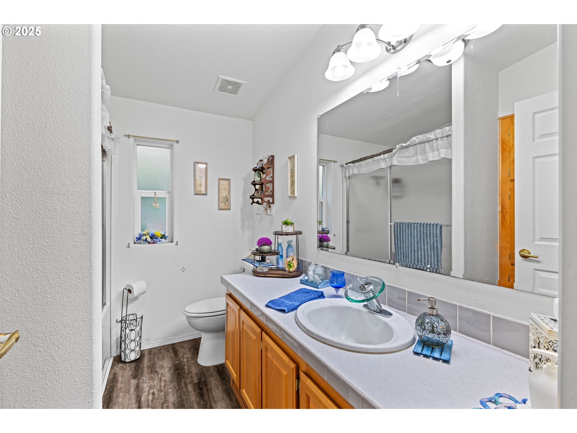 57418 Woodland Road Coquille, OR 97423 - Photo 22 of 39 a bathroom with a sink vanity mirror and toilet