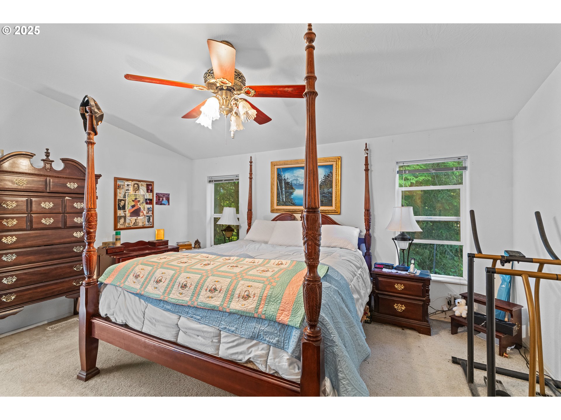 57418 Woodland Road Coquille, OR 97423 - Photo 25 of 39 a bedroom with a bed a chandelier and dresser