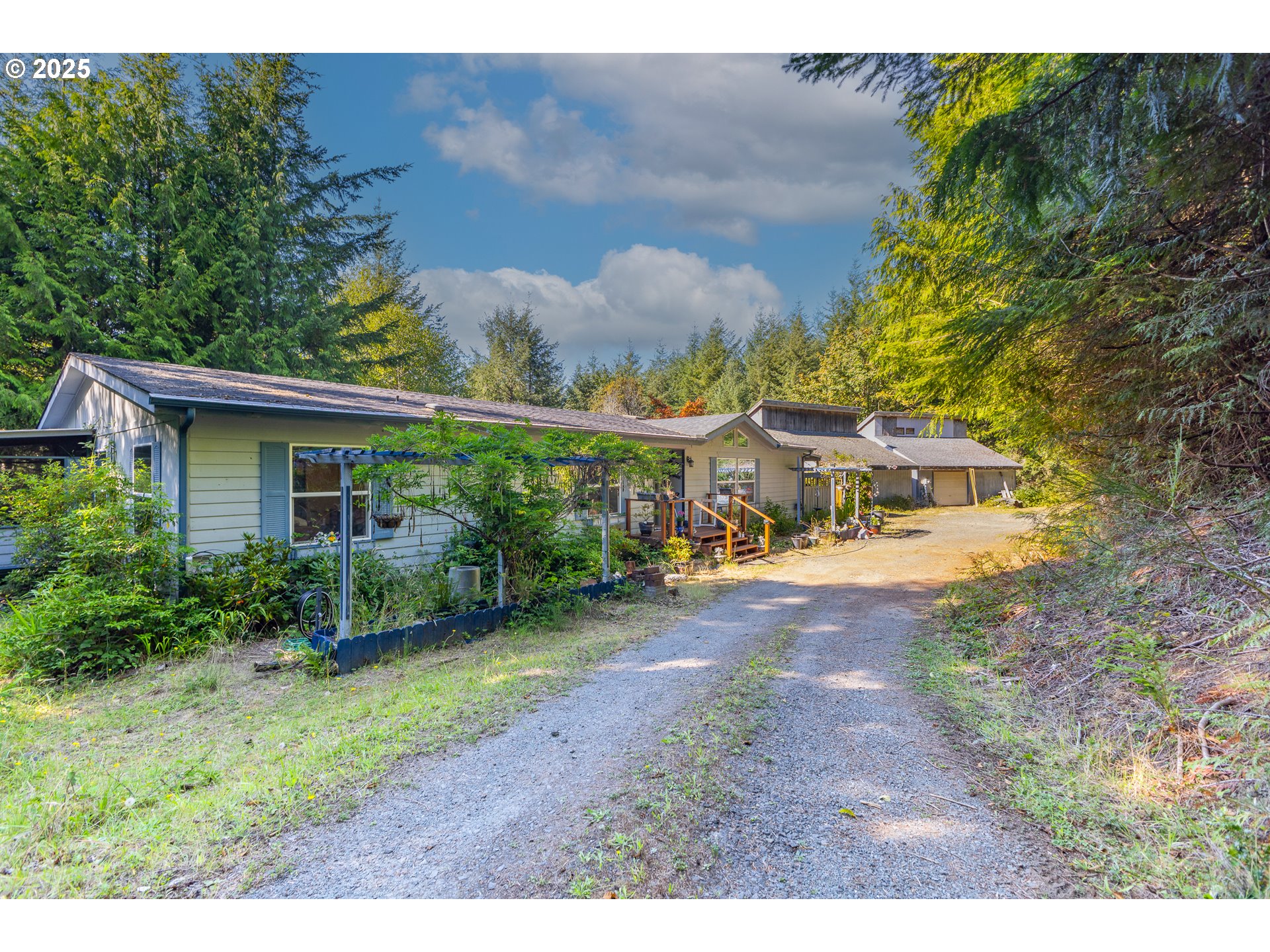 57418 Woodland Road Coquille, OR 97423 - Photo 39 of 39 a view of a house with backyard and garden