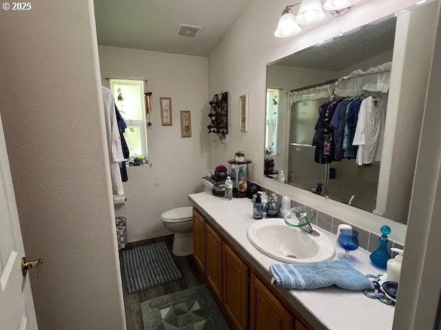 57418 Woodland Road Coquille, OR 97423 - Photo 7 of 39 a bathroom with a granite countertop sink toilet and mirror