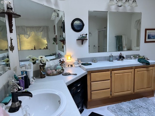57418 Woodland Road Coquille, OR 97423 - Photo 9 of 39 a bathroom with a sink double vanity and mirror