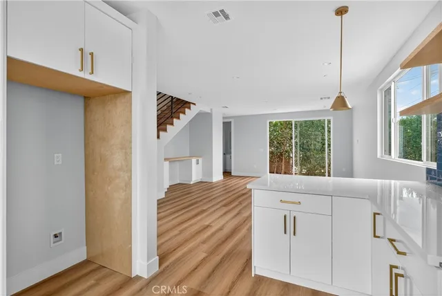a view of a bedroom with wooden floor and windows
