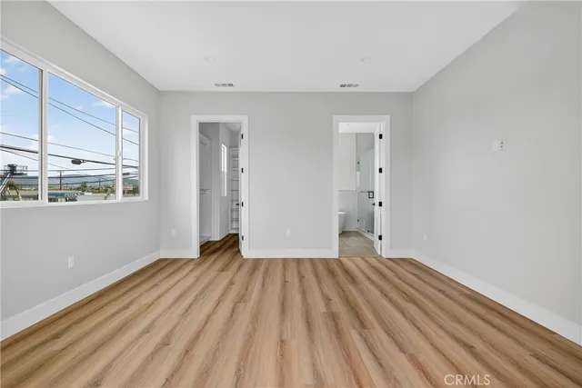 a spacious bathroom with a double vanity sink mirror and bathtub