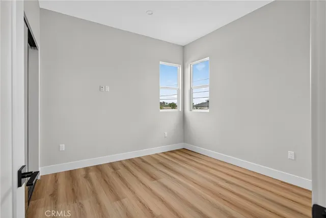a view of room with wooden floor and closet
