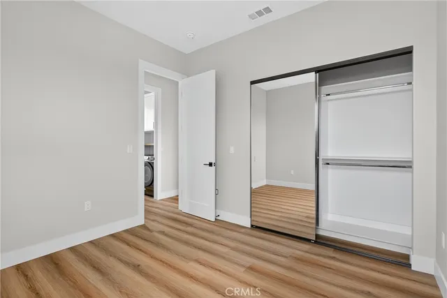 a bathroom with a toilet sink vanity and mirror