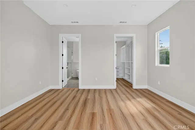 a spacious bathroom with a double vanity sink mirror and bathtub