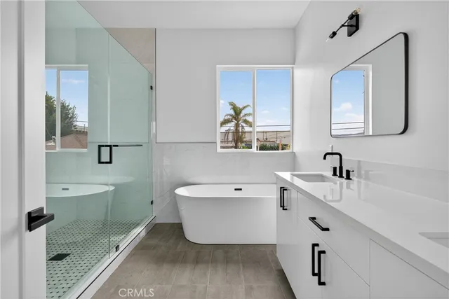 a bathroom with a bathtub sink and mirror