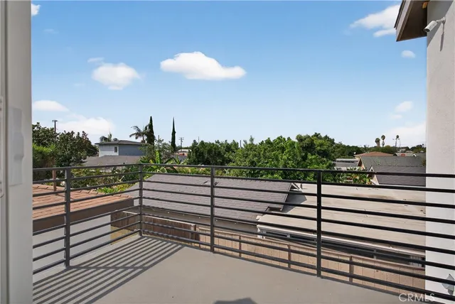 a view of a balcony with a couple of cars parked in front of it