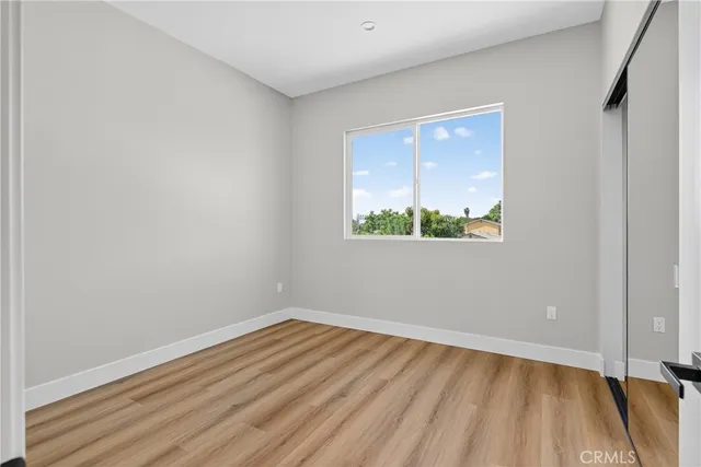 a view of an empty room and wooden floor