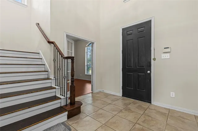 a view of entryway with wooden floor and stairs