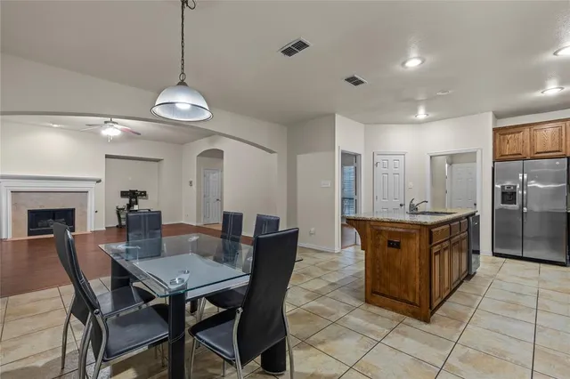 a large kitchen with a table and chairs