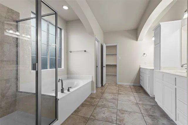 a bathroom with a bathtub and a shower