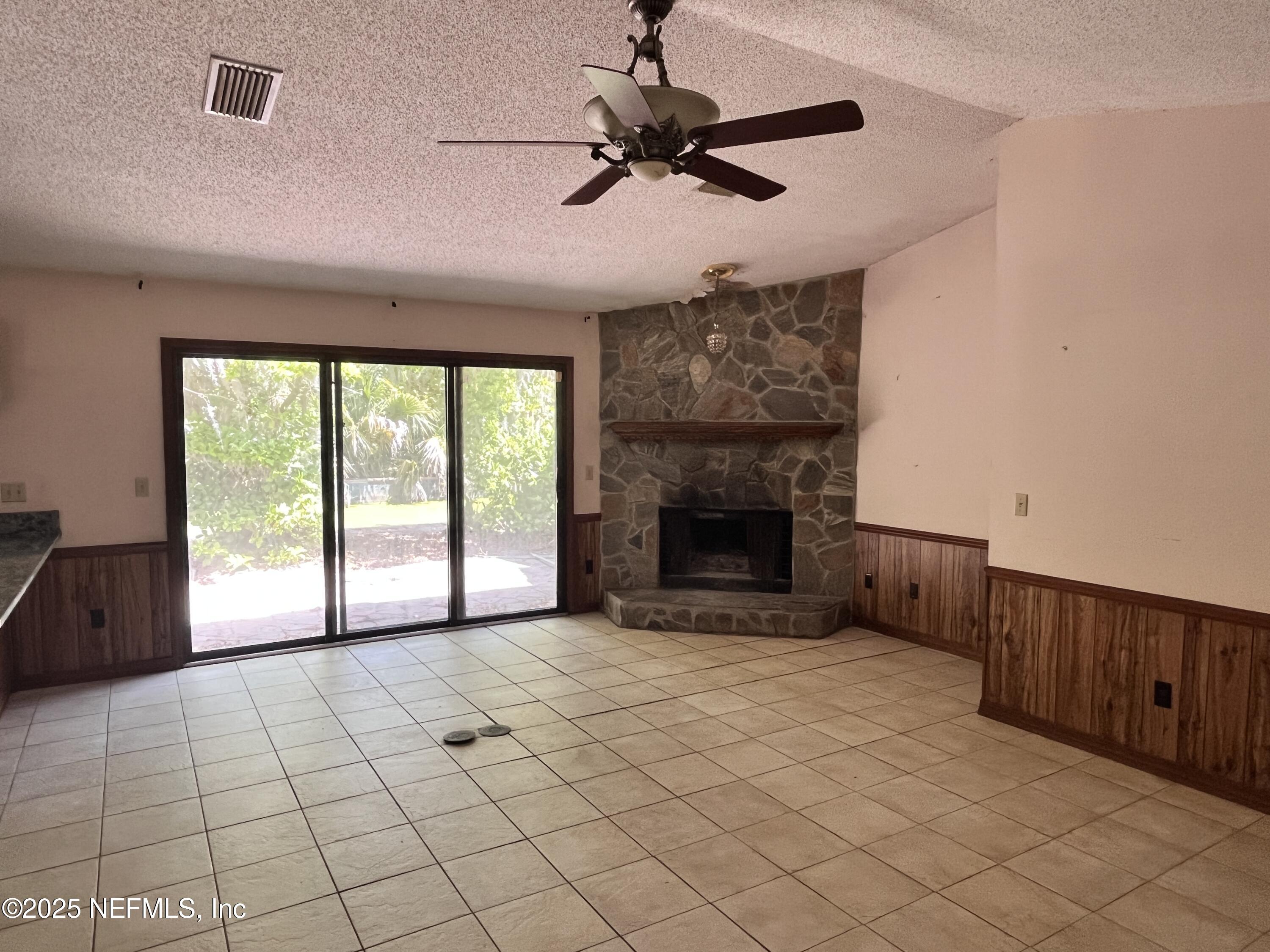 5511 Heckscher Drive Jacksonville, FL 32226 - Photo 11 of 19 a view of empty room with fireplace and fan
