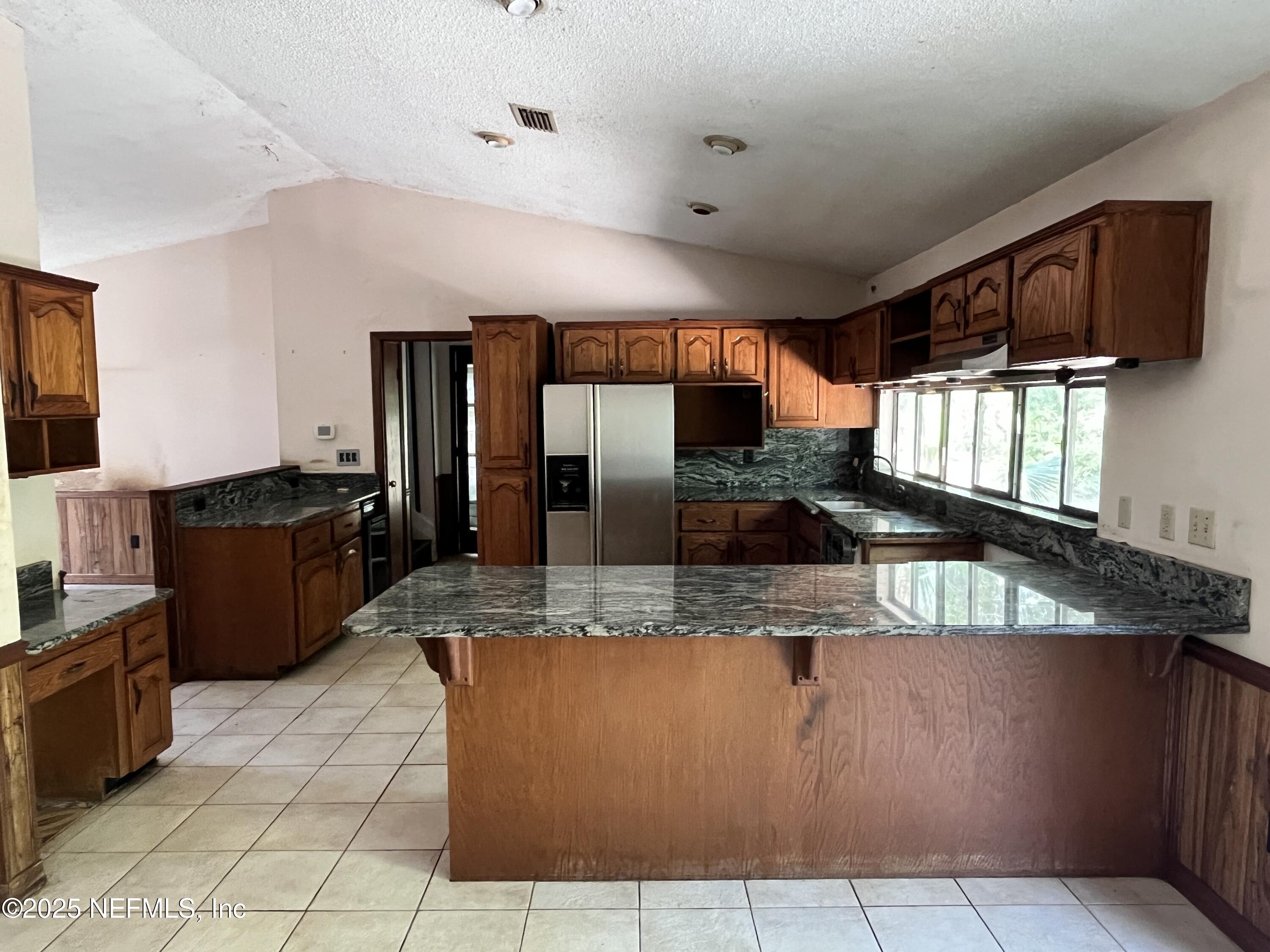 5511 Heckscher Drive Jacksonville, FL 32226 - Photo 12 of 19 a large kitchen with kitchen island granite countertop a large counter top stainless steel appliances and cabinets