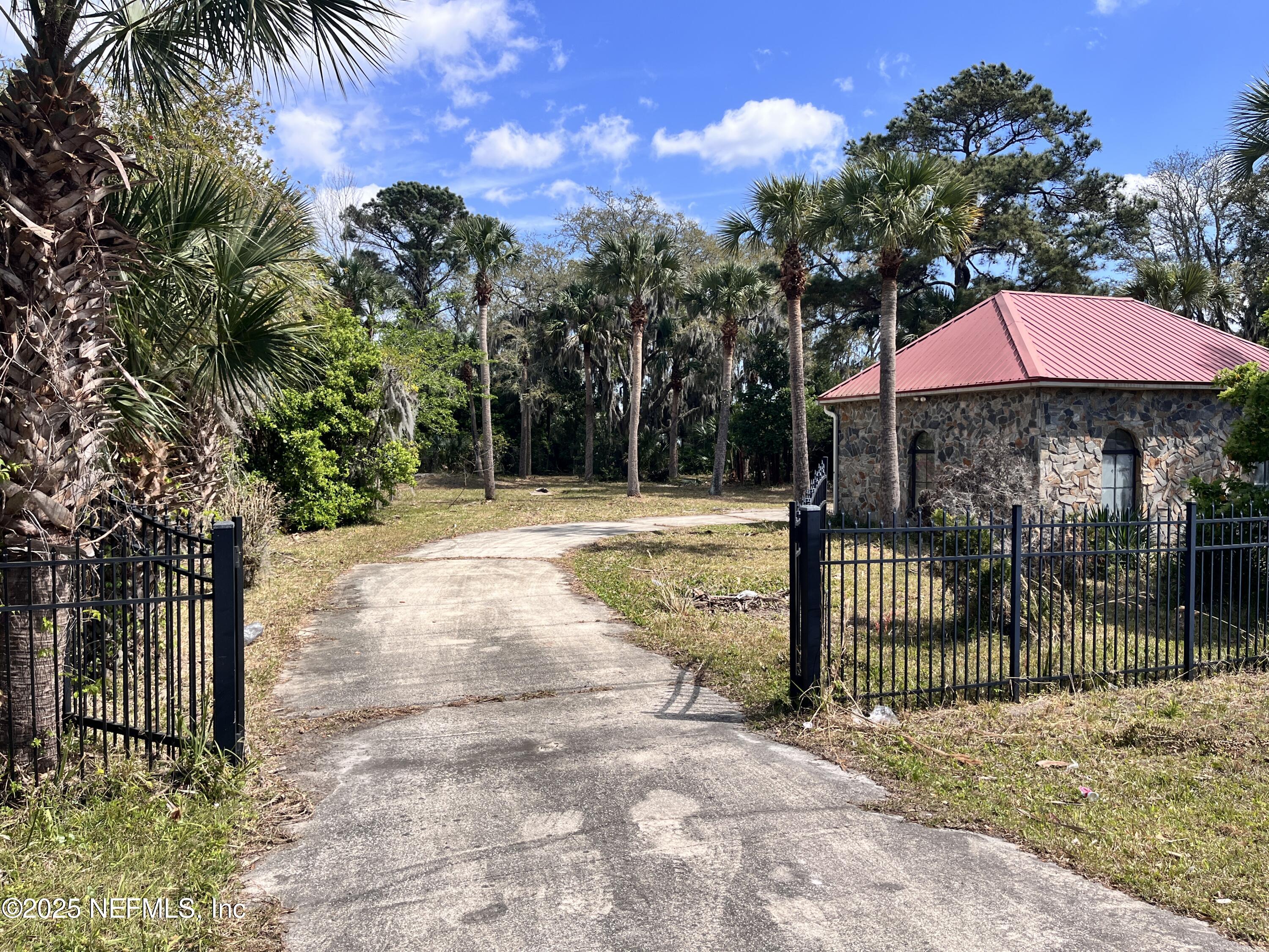 5511 Heckscher Drive Jacksonville, FL 32226 - Photo 4 of 19 a view of a patio with a table and chairs under an umbrella