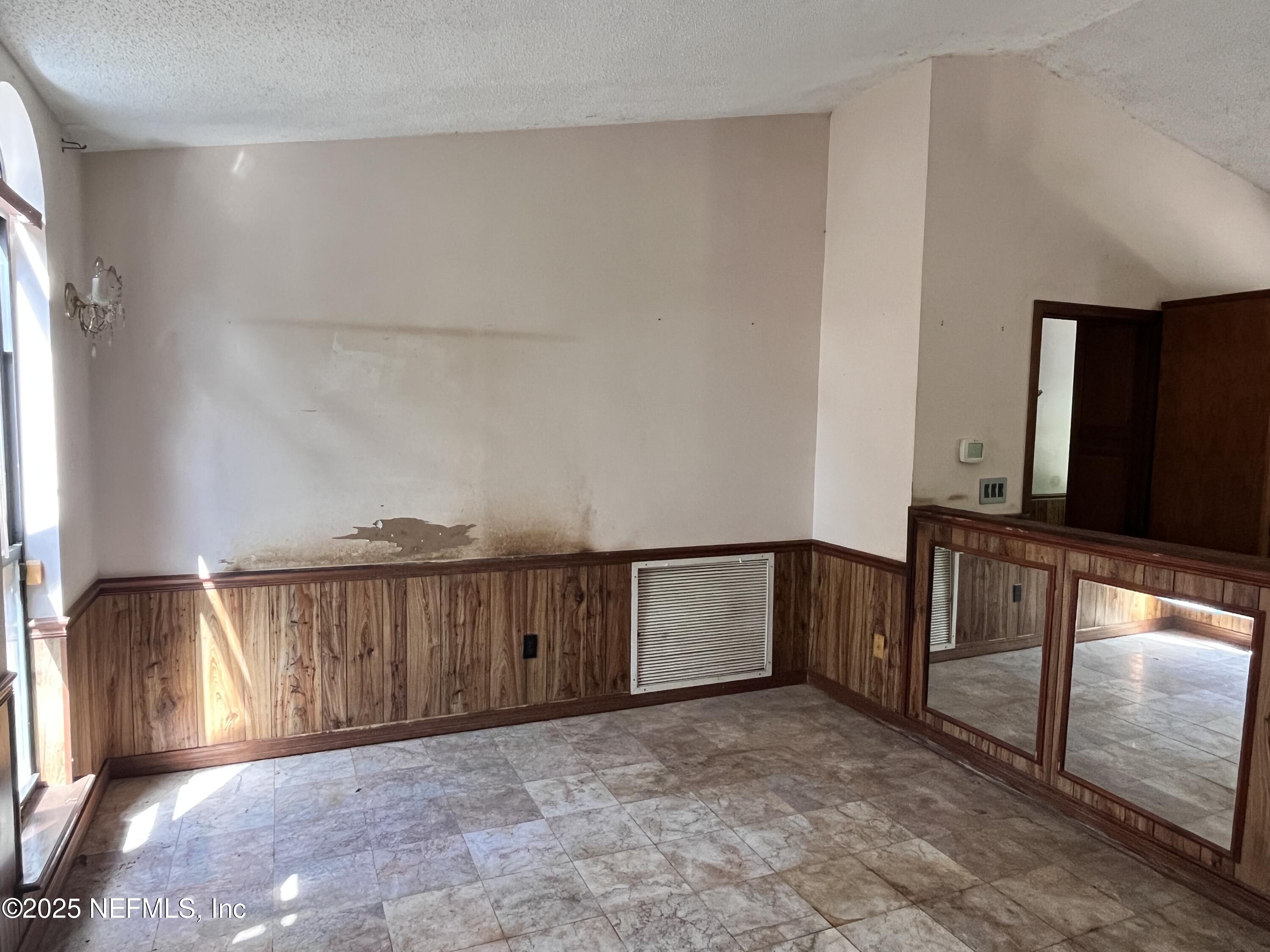 5511 Heckscher Drive Jacksonville, FL 32226 - Photo 8 of 19 a view of an empty room with wooden floor and a window