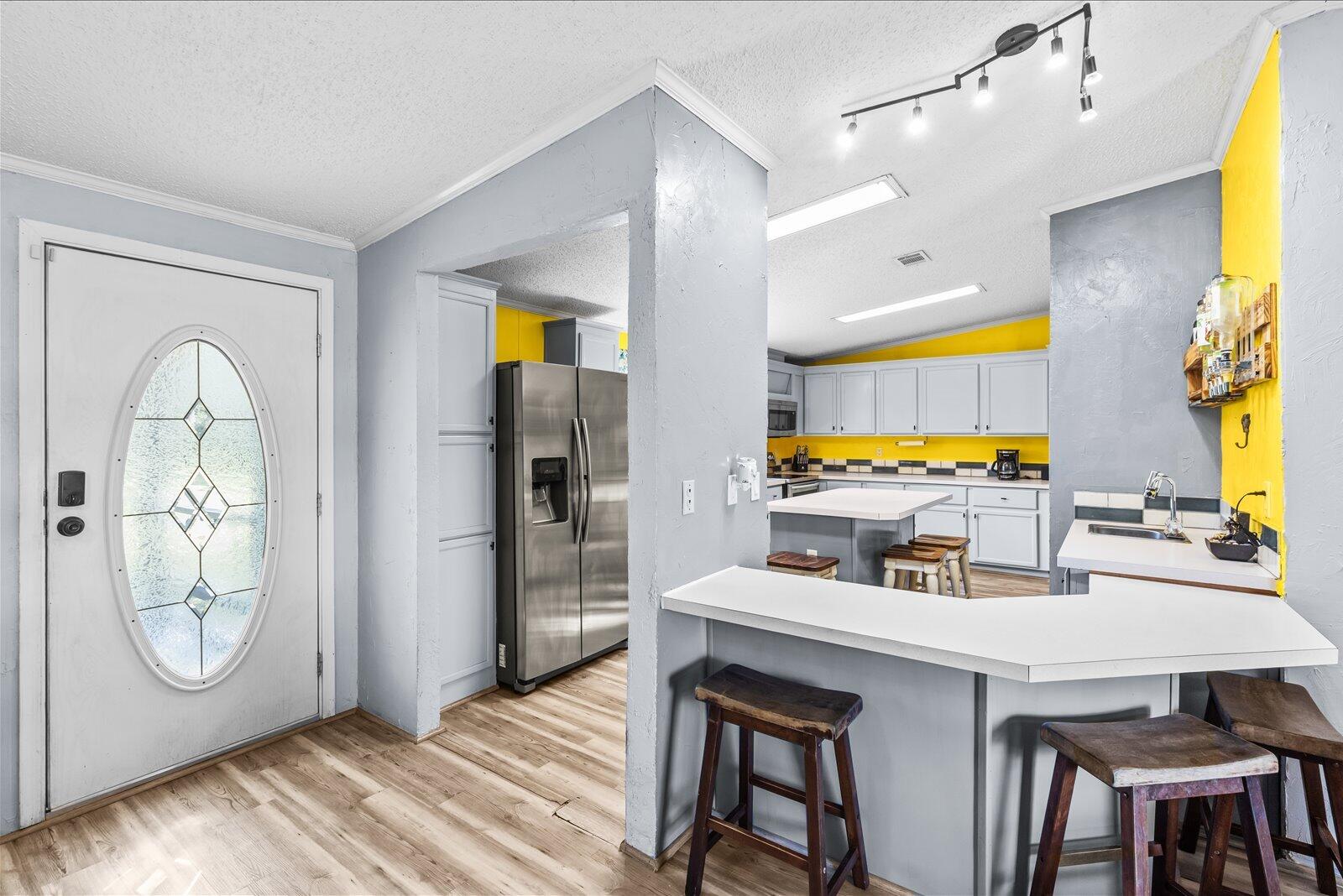 23801 Southwest Martin Highway Okeechobee, FL 34974 - Photo 45 of 85 a kitchen with a table chairs and a refrigerator