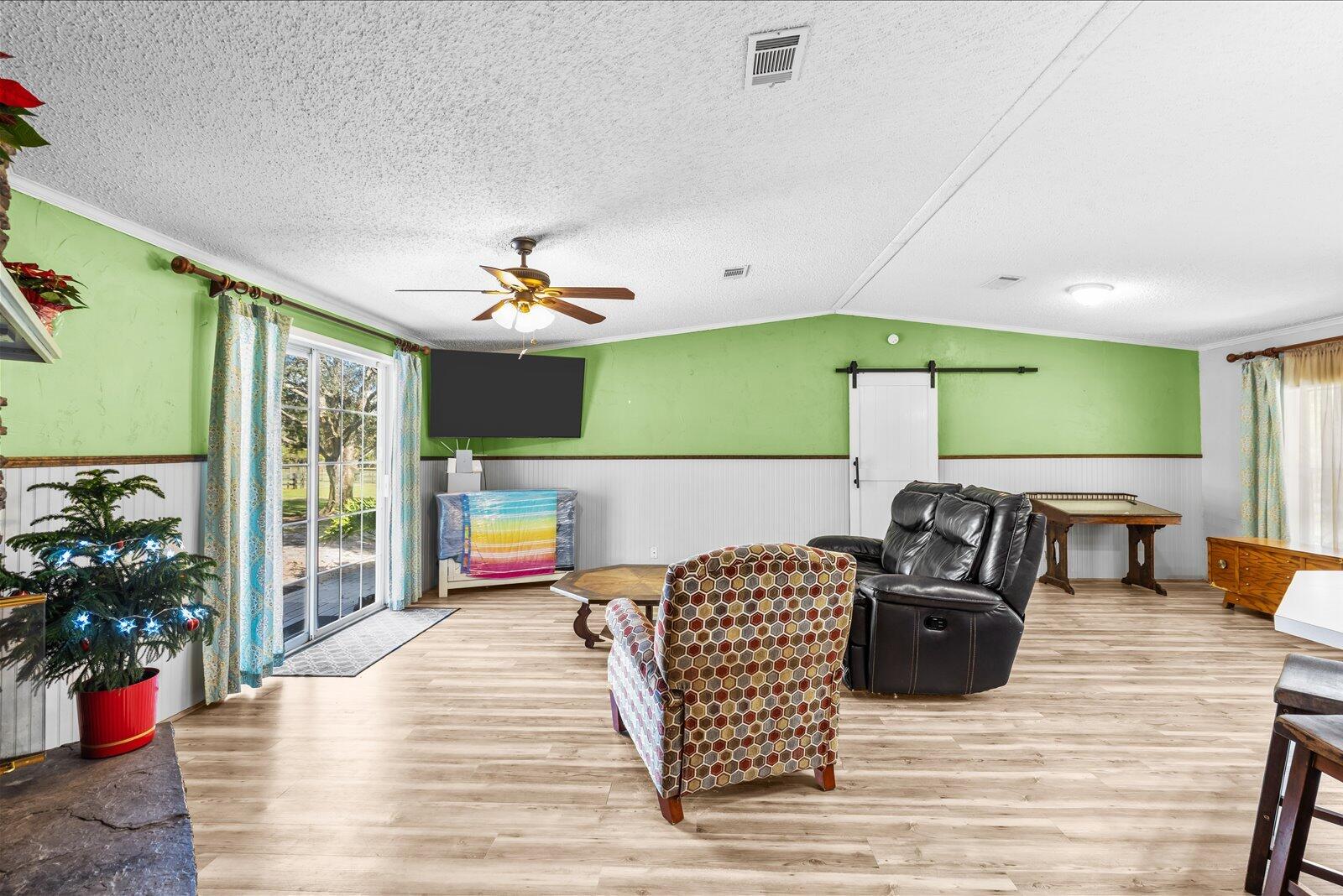 23801 Southwest Martin Highway Okeechobee, FL 34974 - Photo 49 of 85 a living room with furniture and a chandelier