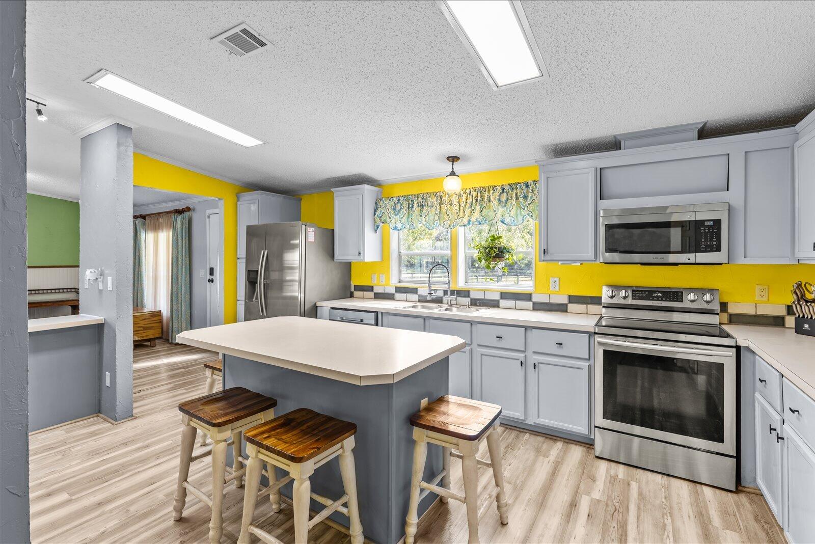 23801 Southwest Martin Highway Okeechobee, FL 34974 - Photo 50 of 85 a kitchen with a stove a sink and a microwave