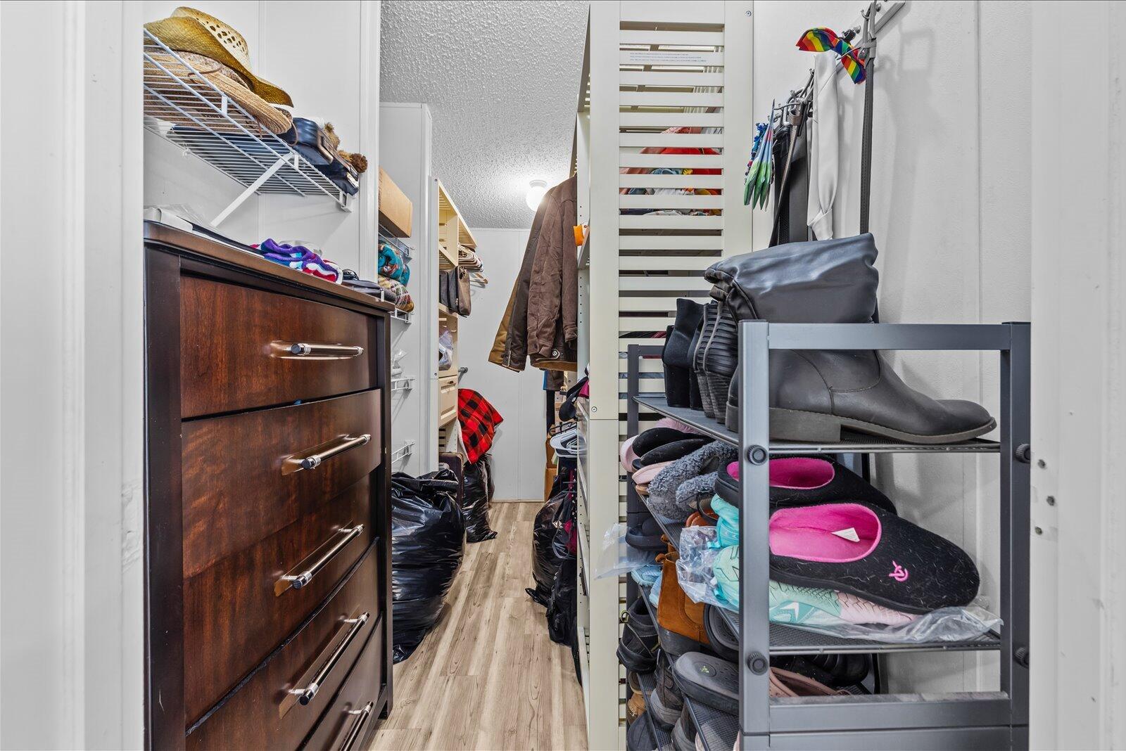 23801 Southwest Martin Highway Okeechobee, FL 34974 - Photo 61 of 85 a view of walk in closet with clothes and shoes