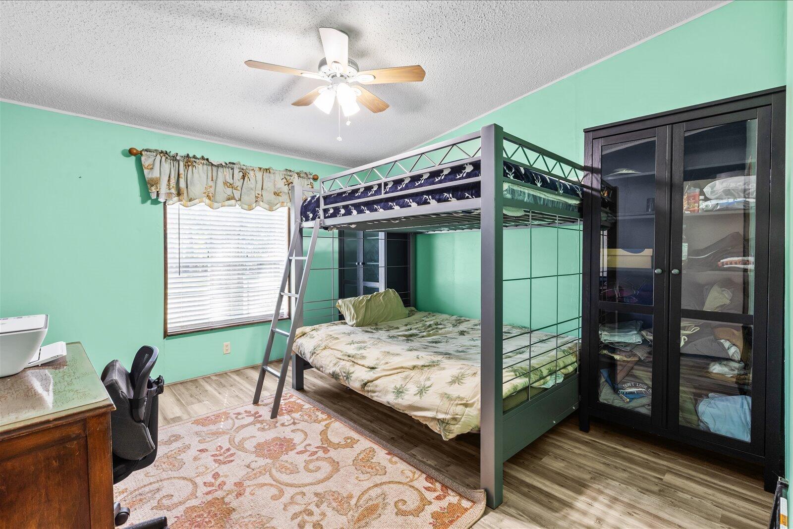 23801 Southwest Martin Highway Okeechobee, FL 34974 - Photo 62 of 85 a bedroom with a bed and a window