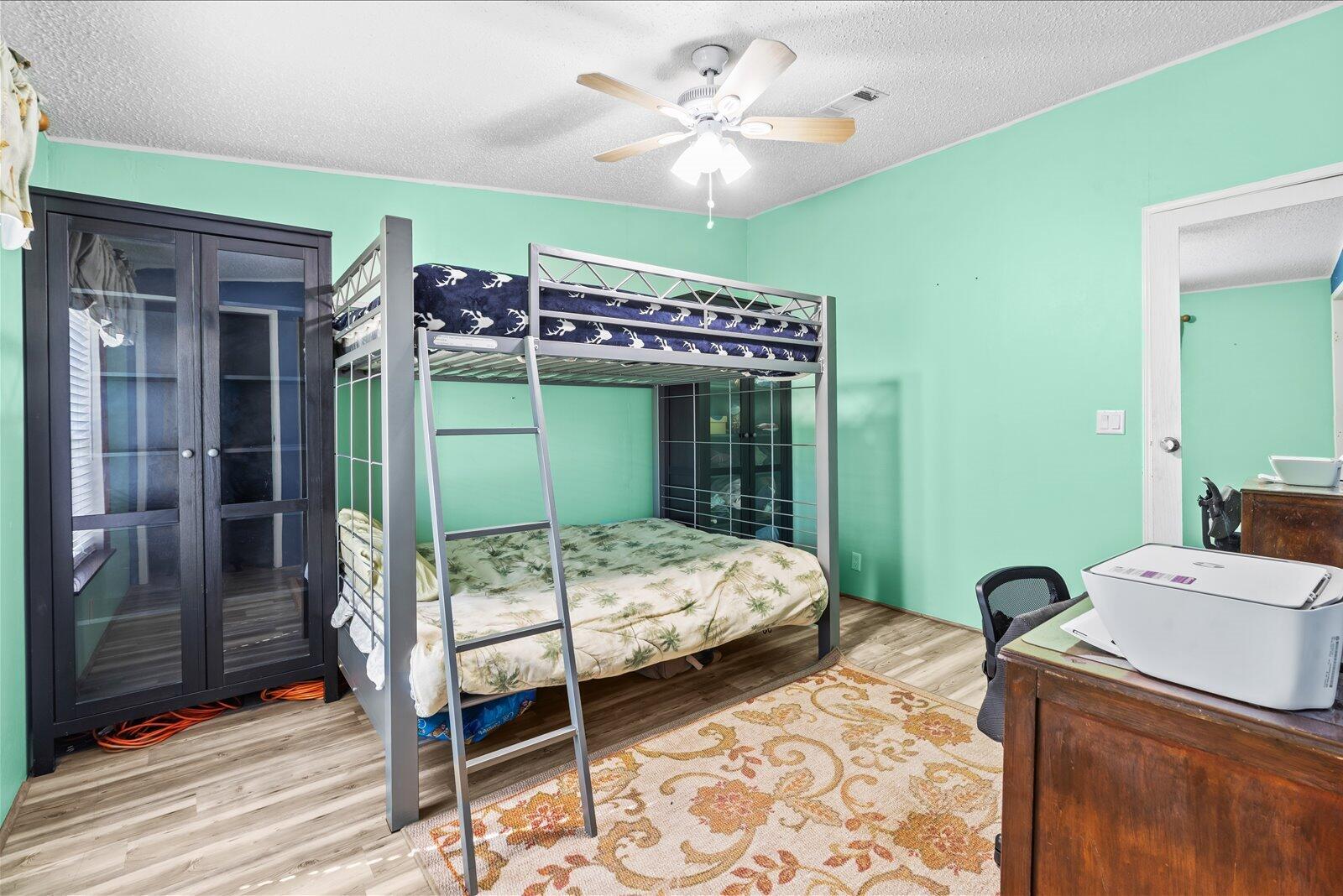 23801 Southwest Martin Highway Okeechobee, FL 34974 - Photo 63 of 85 a bedroom with a bed and a chandelier