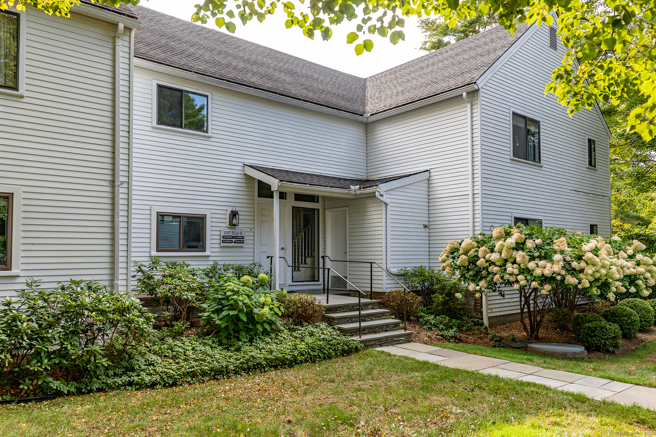 a front view of a house with a garden