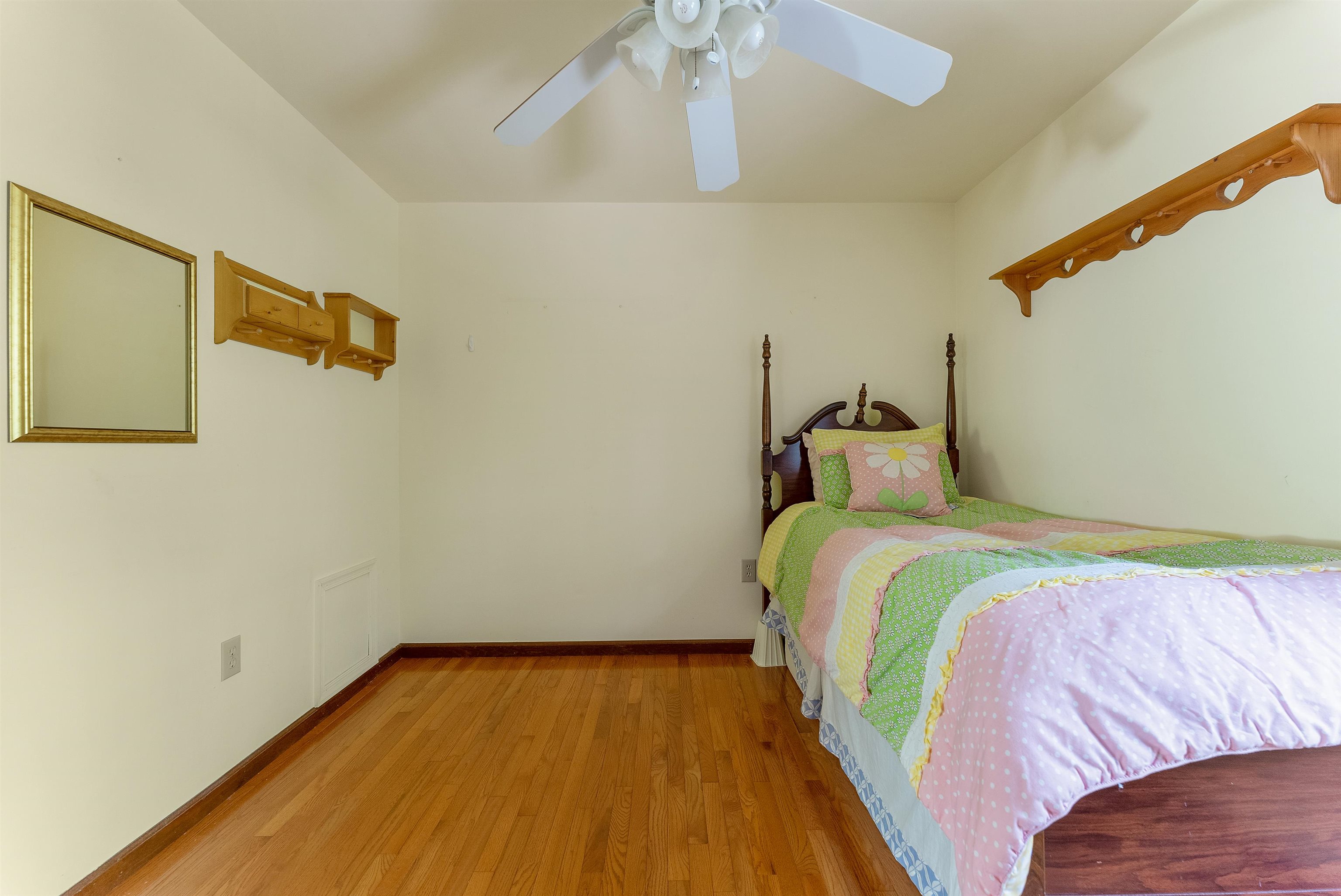 233 Fidler Road Dennisville, NJ 08270 - Photo 16 of 31 a bedroom with a bed and wooden floor