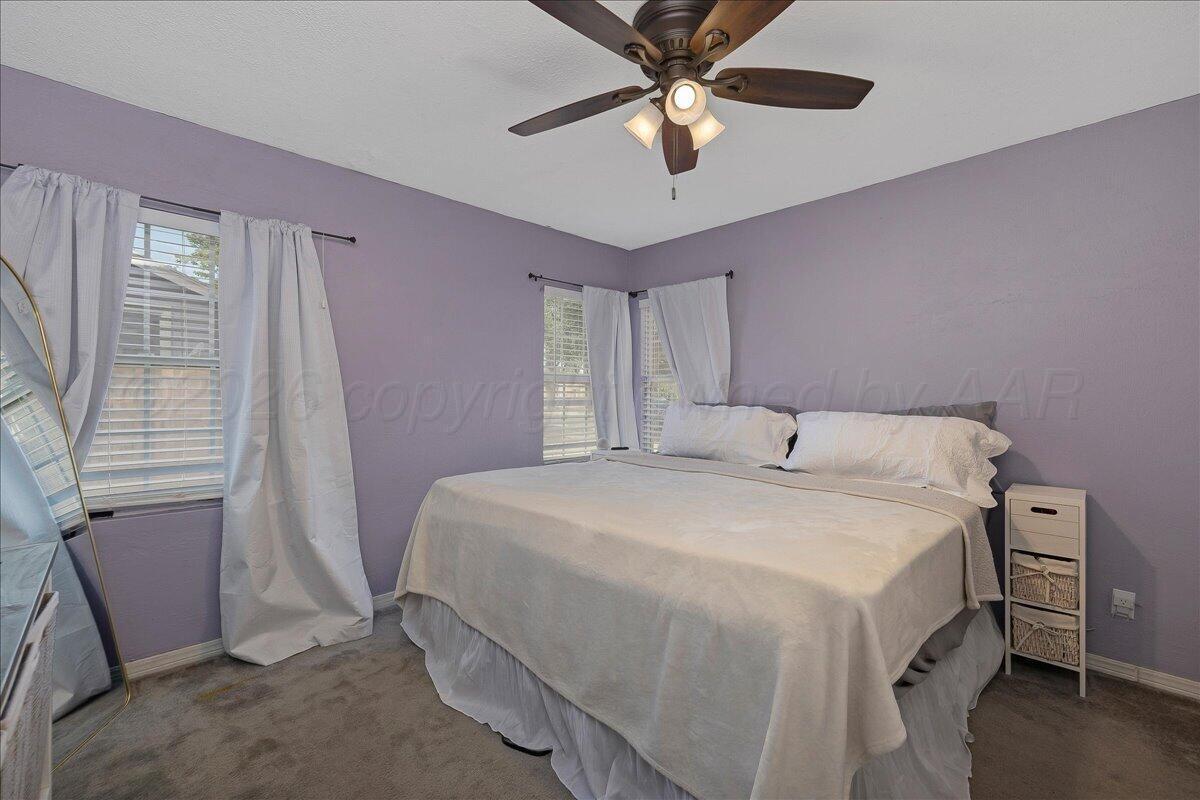 4011 Parker Street Amarillo, TX 79110 - Photo 9 of 17 a bedroom with a bed and a ceiling fan