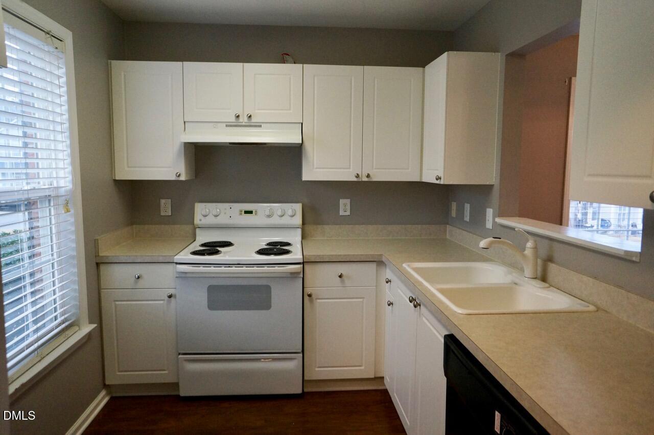 2444 Pumpkin Ridge Way Raleigh, NC 27604 - Photo 3 of 19 a kitchen with granite countertop white cabinets and white appliances