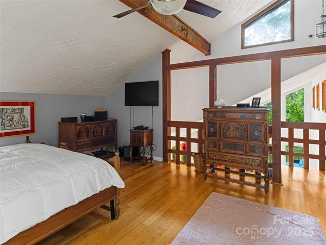 a bedroom with furniture and a large window