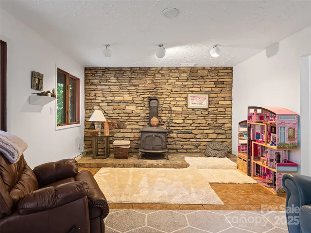 a living room with furniture and a book shelf