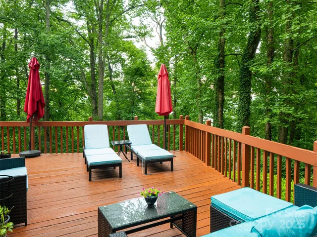 a roof deck with wooden floor and outdoor seating
