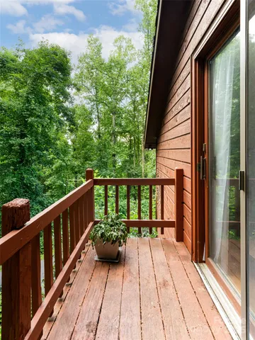 a view of balcony with a potted plant and floor to ceiling window